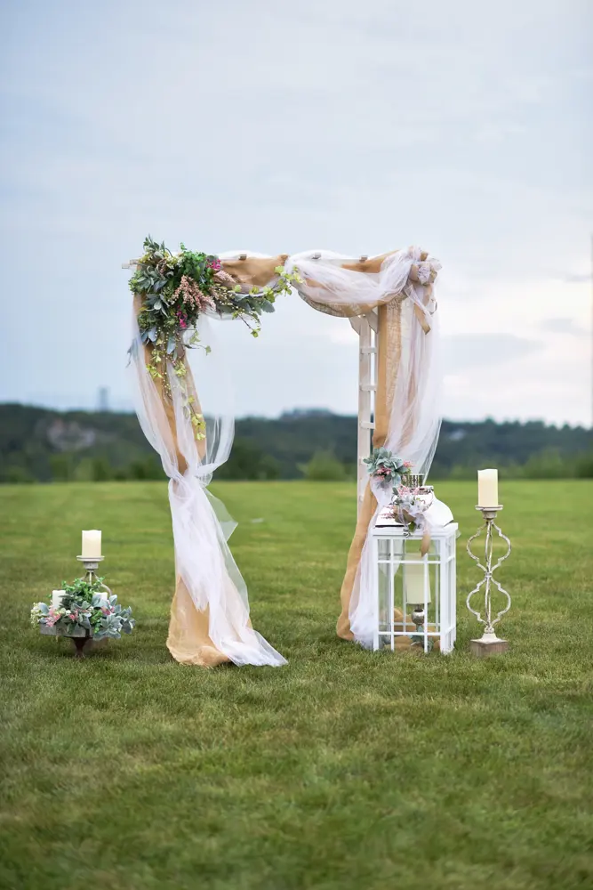 A floral wedding arch standing in the open field