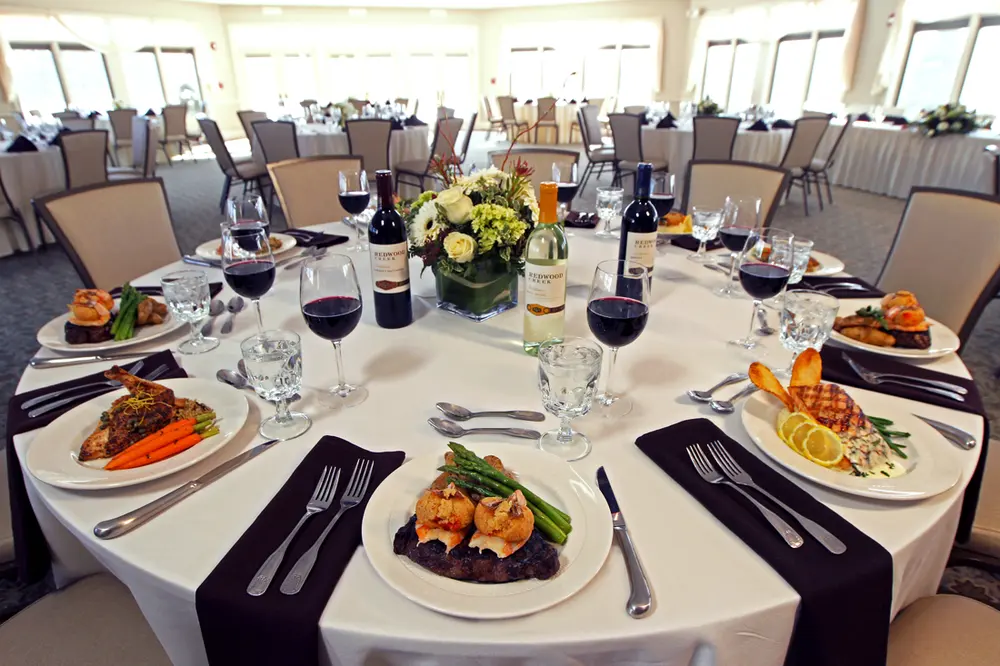 Round tables set for a luncheon with a view of the grounds