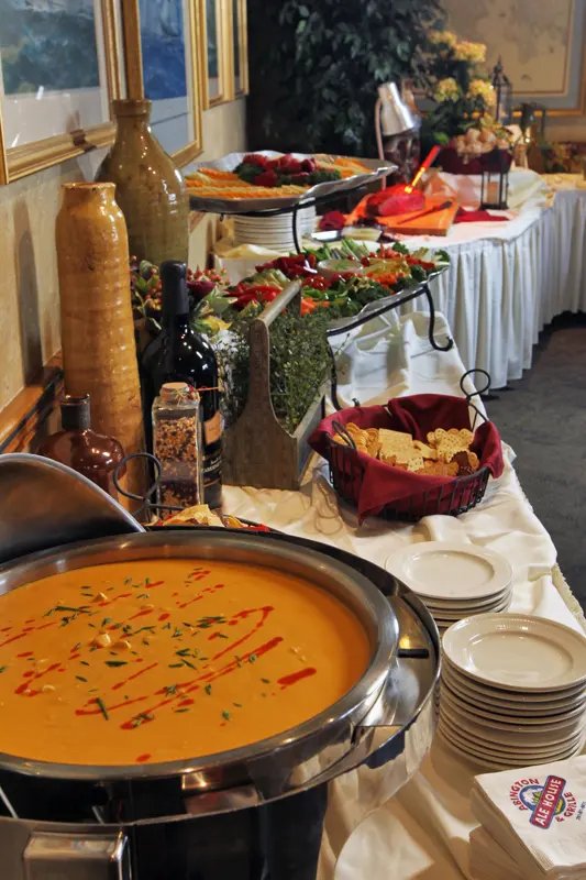 Buffet station with soup and a wine glass