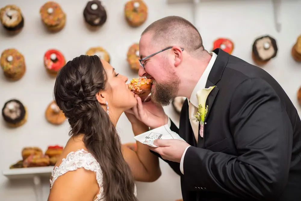 Couple sharing a donut wall treat