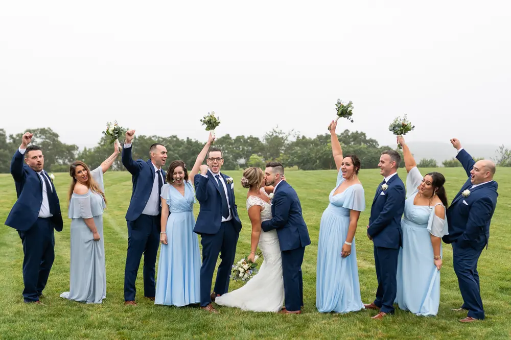 Wedding party celebrating on the lawn