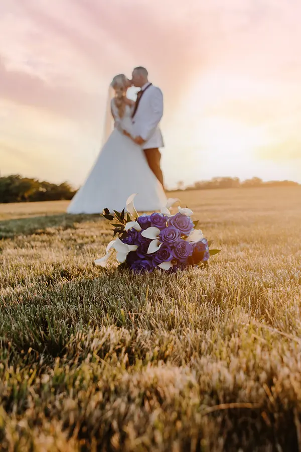 Couple in the fields at sunset